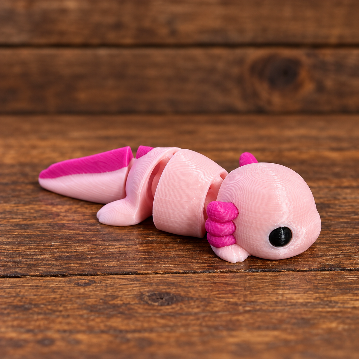 3D printed Little Critters toy on rustic wood background
