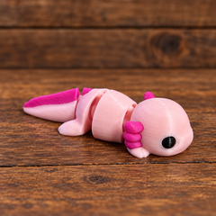 3D printed Little Critters toy on rustic wood background