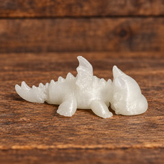 3D printed Little Critters toy on rustic wood background